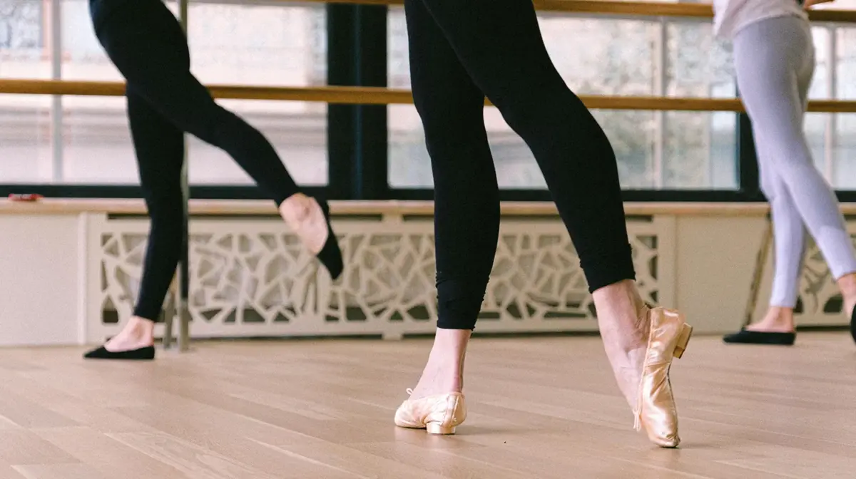 zoom of 3 women's legs in ballet class