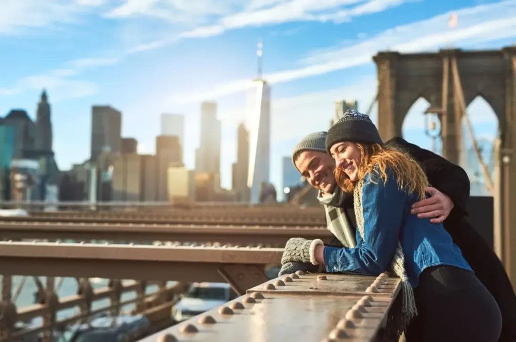 Couple walking the Brooklyn Bridge during winter in an Effortless New York City Trip